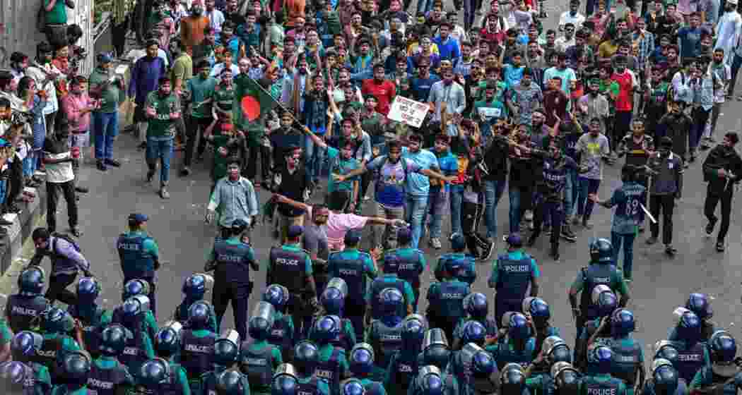 Security personnel confront protesters during anti-quota demonstrations in Dhaka.