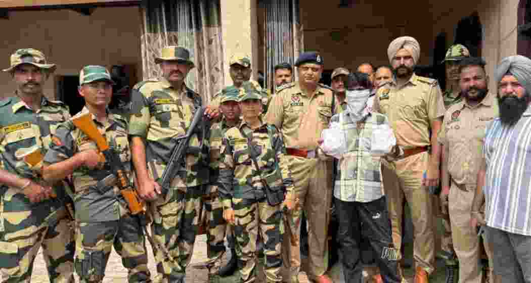 Police personnel hold a man arrested with 3.5 kilograms of heroin during a raid in Ferozepur last Friday, as part of Punjab’s intensified anti-narcotics crackdown.