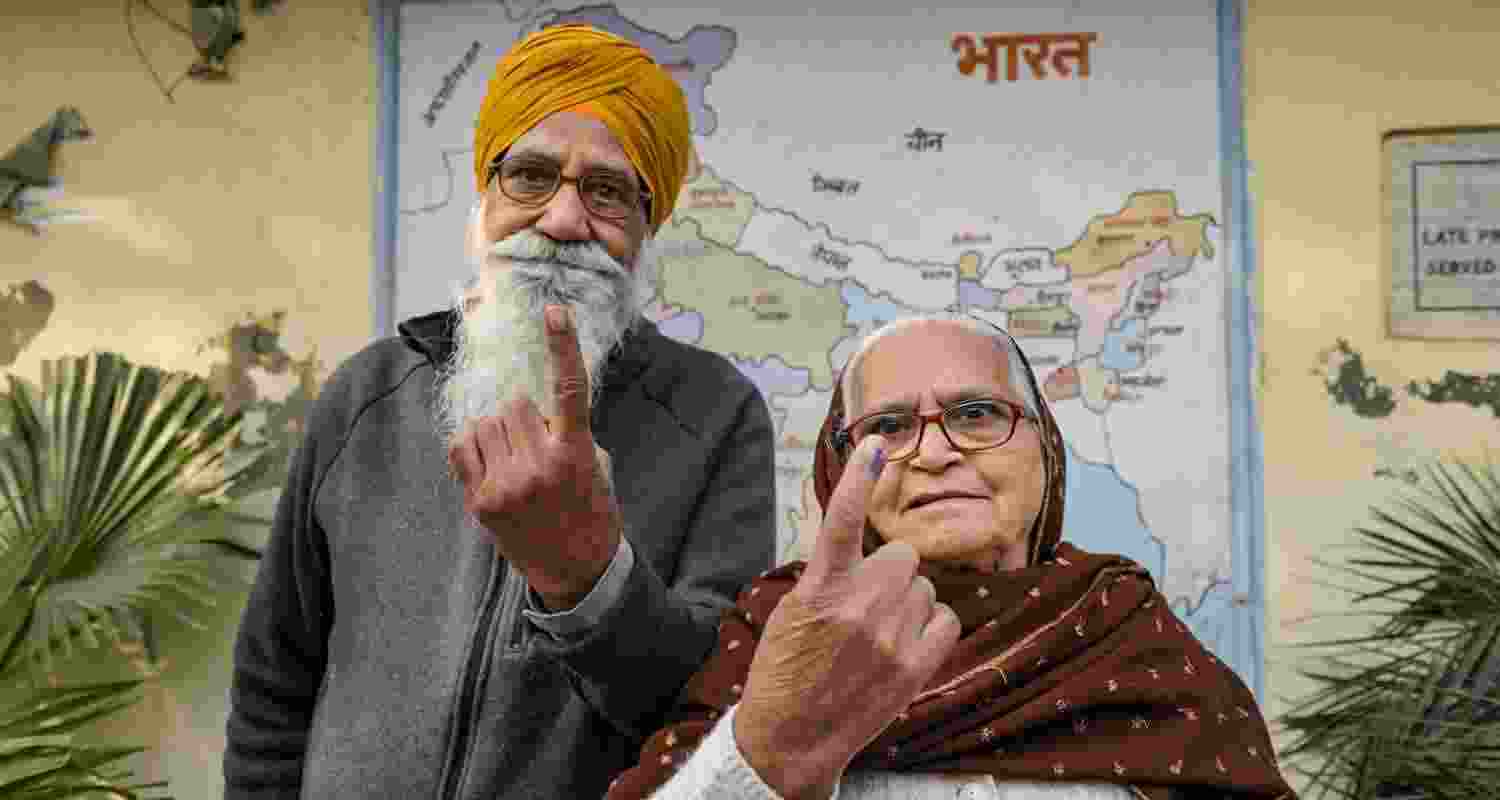 People show their ink-marked fingers after casting votes for Punjab Municipal Corporation elections, in Amritsar, Saturday. 