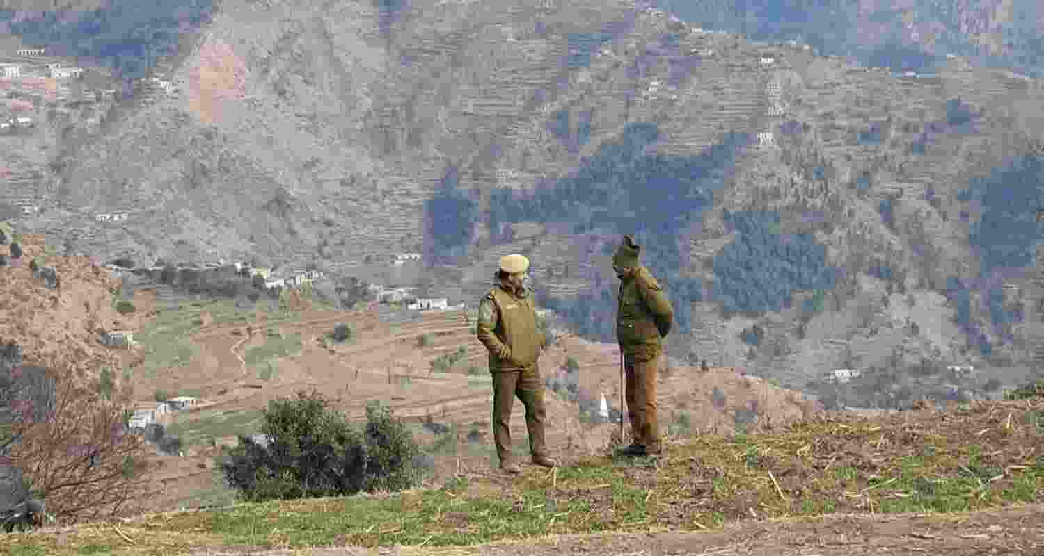 Security personnel kept vigil after the remote Badhaal village was declared a containment zone and prohibitory orders imposed on all public and private gatherings in the wake of the death of 17 people belonging to three families, in Jammu and Kashmir's Rajouri district, Wednesday. 