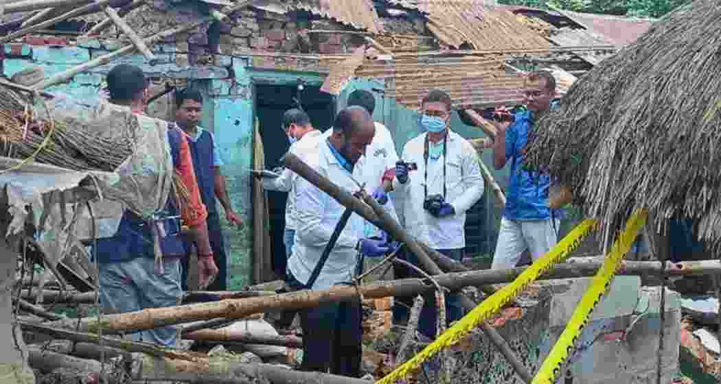 Security personnel inspect the blast site in Rajua village, East Burdwan district.