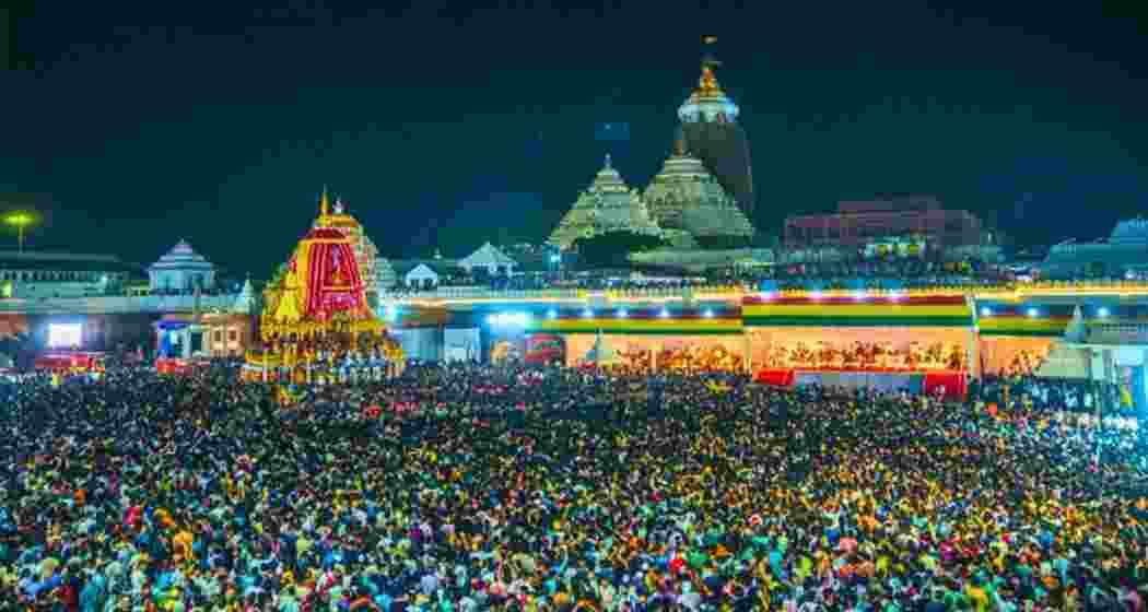 Thousands of people on Friday, together, offer prayers before one of the towering chariots during the Rath Yatra procession in Puri, as it begins its journey to the Gundicha Temple.