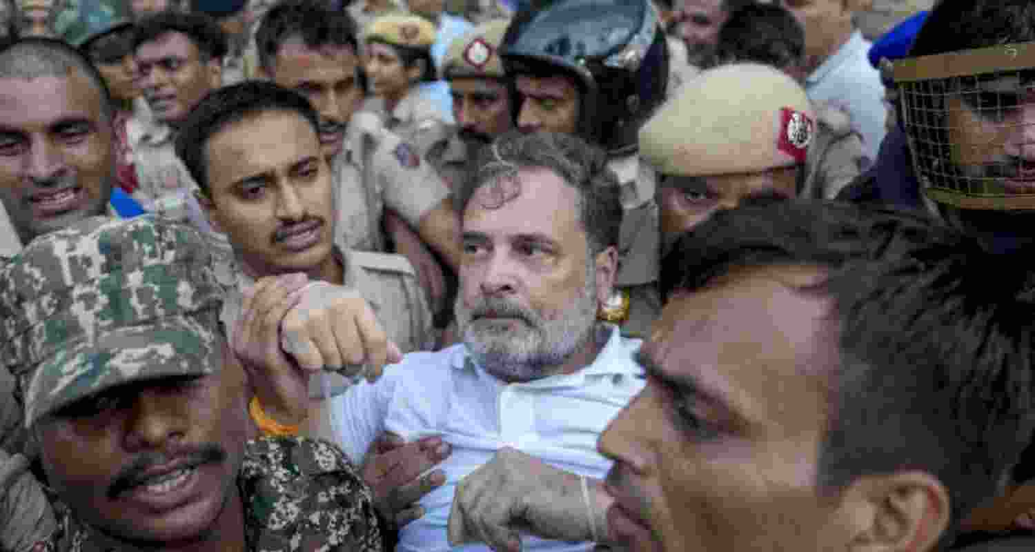 Congress leader Rahul Gandhi being detained by the police during the party's "Chalo PM House" march in New Delhi on Tuesday.