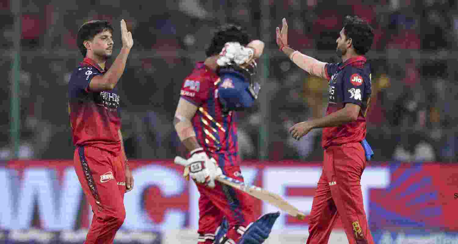 Royal Challengers Bengaluru's Rasikh Salam, left, with teammates celebrates after taking the wicket of Lucknow Super Giants' Ayush Badoni during the Indian Premier League (IPL) 2026 T20 cricket match between Royal Challengers Bengaluru and Lucknow Super Giants, at M Chinnaswamy Stadium in Bengaluru, Karnataka, Wednesday, April 15, 2026. 