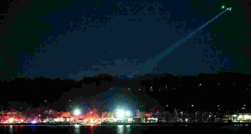 A rescue helicopter hovers over the Potomac River following a mid-air collision between a commercial airplane and a military helicopter near Ronald Reagan National Airport, Washington, DC.