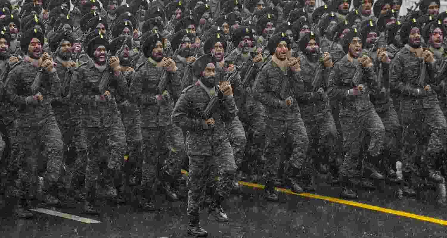 Indian Army contingent marches during rain-affected full-dress rehearsal for the Republic Day Parade, in New Delhi, Friday