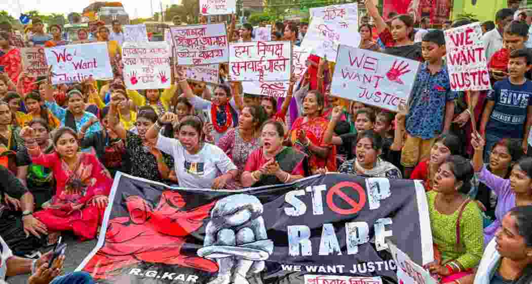 People protesting against the RG Kar rape-murder incident, demanding justice and questioning women’s safety in West Bengal.
