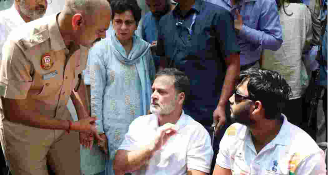 Rahul Gandhi with Sahil Lochab, one of the victims of the reported use of pellet guns during the July 20 protest, at a sit-in outside the Parliament Street Police Station. 