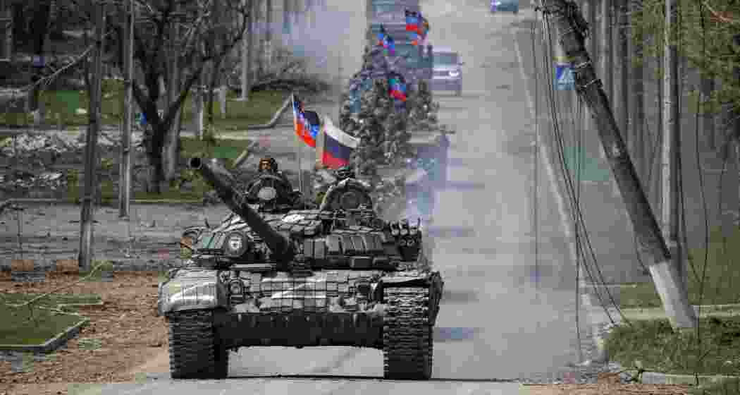 An armored convoy of pro-Russian troops moves along a road during the Ukraine-Russia conflict.