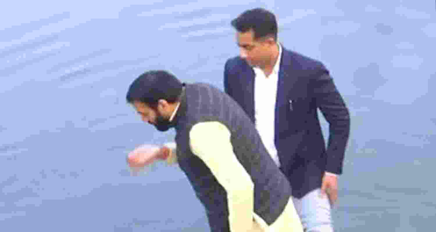 Haryana CM Saini takes sip of Yamuna water. 