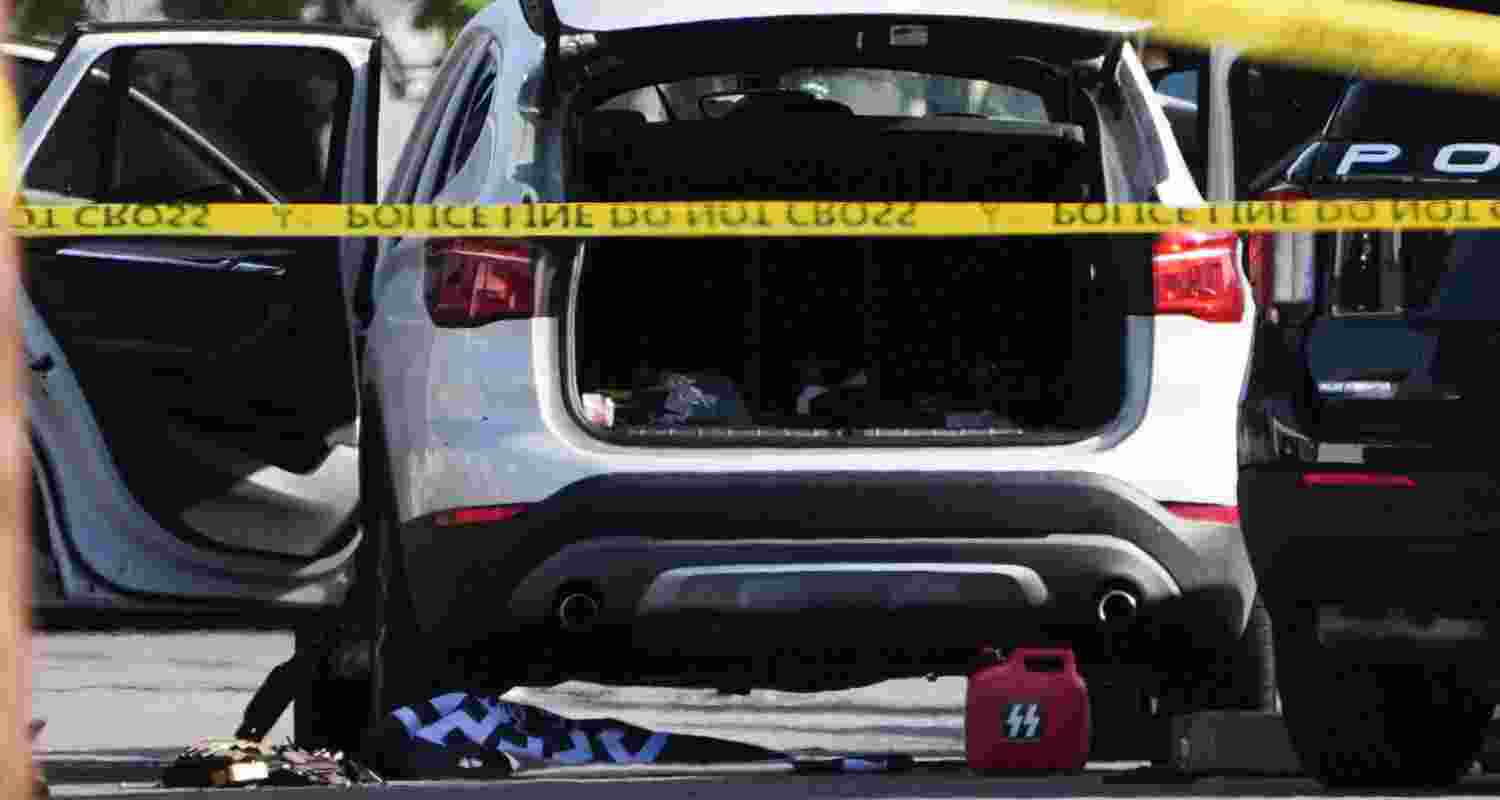 A vehicle's hatch and doors are opened near where a body of one of the shooters was placed near the scene of a shooting outside the Islamic Center of San Diego Monday, May 18, 2026, in San Diego.