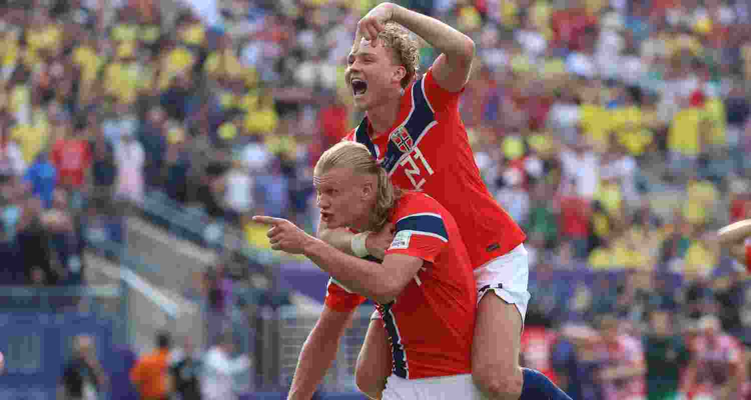 Erling Haaland celebrates with teammates after scoring Norway's first goal.