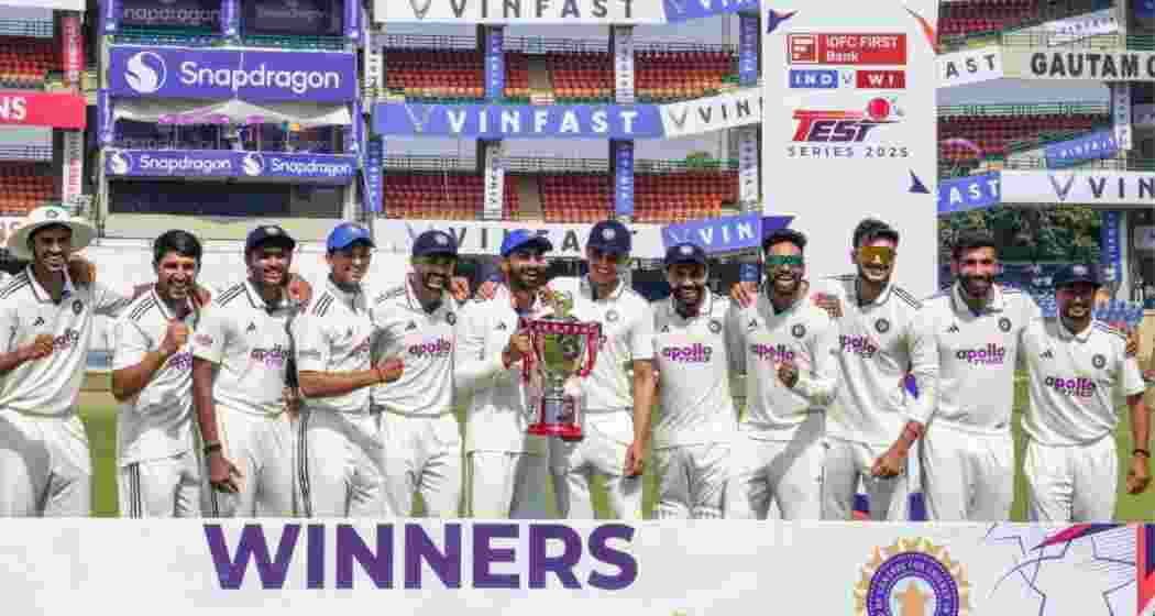 India's players celebrate with the trophy after winning the Test series against West Indies at Feroz Shah Kotla Stadium in New Delhi on Tuesday.