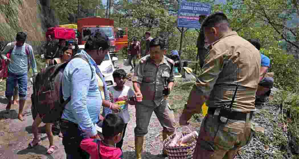 Officials and personnel from the Sikkim government provide food to rescued individuals during evacuation efforts in North Sikkim following road blockages caused by landslides.
