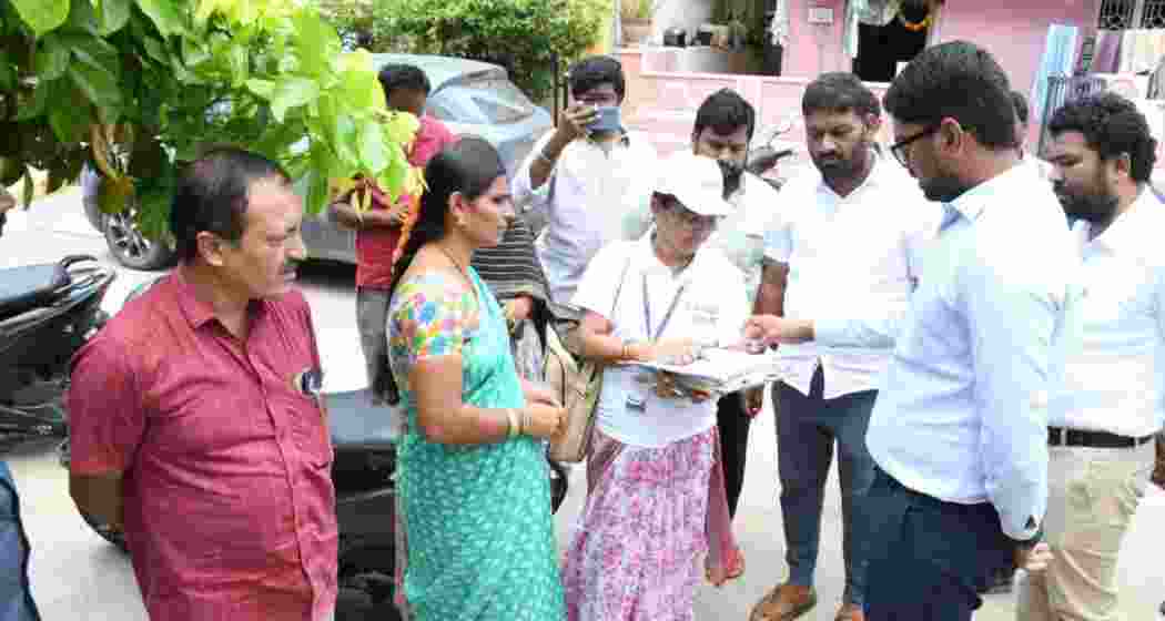 Wanaparthy District Collector Adarsh Surabhi interacts with residents during the door-to-door voter enumeration exercise launched across Telangana as part of the Special Intensive Revision process.