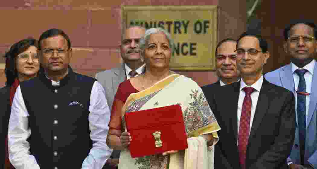 Union Minister for Finance and Corporate Affairs Nirmala Sitharaman along with the Ministers of State for Finance Pankaj Chaudhary and team members of Finance, outside the her office at North Block in New Delhi.