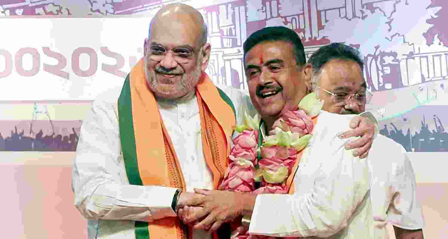 Union Home Minister Amit Shah with BJP leader Suvendu Adhikari during a press conference after the BJP legislature party meeting, in Kolkata, West Bengal, Friday. Adhikari was elected the leader of the BJP legislature party in West Bengal on Friday, paving the way for him to become the first BJP chief minister of the state. Union Home Minister Amit Shah with BJP leader Suvendu Adhikari during a press conference after the BJP legislature party meeting, in Kolkata, West Bengal, Friday. Adhikari was elected the leader of the BJP legislature party in West Bengal on Friday, paving the way for him to become the first BJP chief minister of the state.