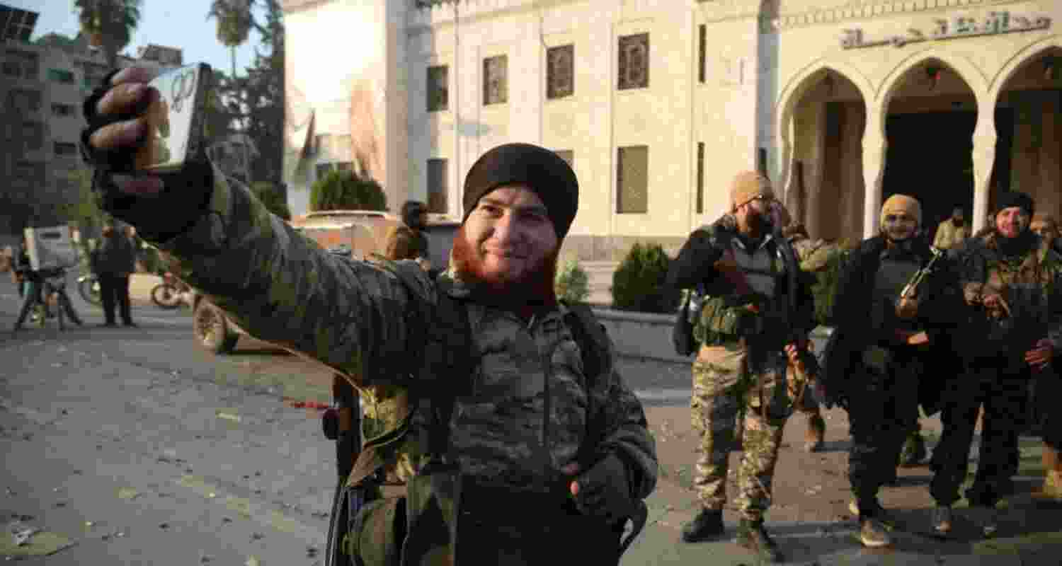 A rebel fighter takes a selfie after the forces captured the city of Hama, Syria.