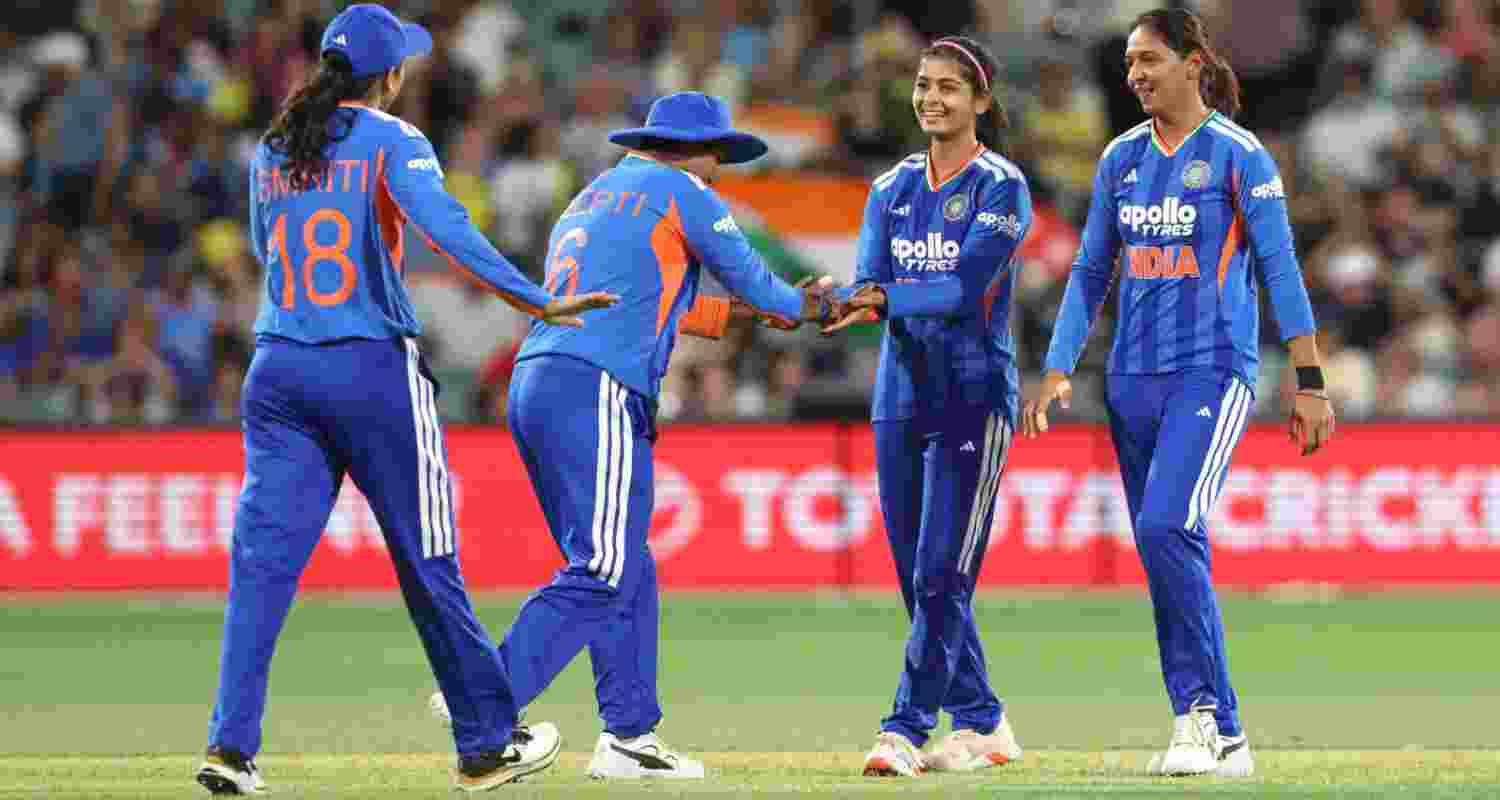 Indian players celebrating the fall of an Australian wicket in the third T20 of the series in Adelaide on Saturday.