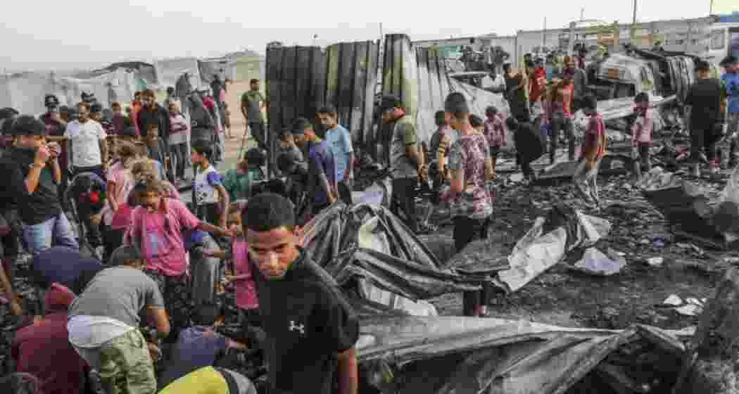 Children wait for food distribution outside the UNRWA shelter in al-Mawasi.