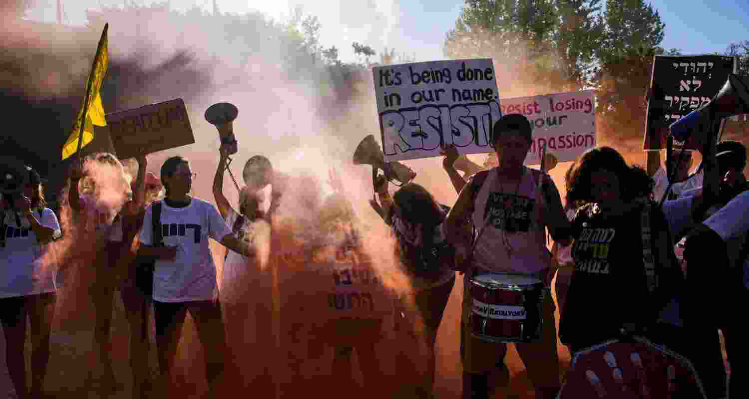 Demonstrators wave signs and shout slogans during a protest demanding the immediate release of all hostages held by Hamas and calling for the end of the war in the Gaza Strip, in Jerusalem.