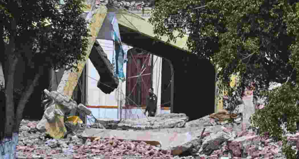A Pakistani soldier walks through the rubble of the Markaz Taiba, the LeT headquarters in Muridke, one of the terror hubs struck during India’s Operation Sindoor.
