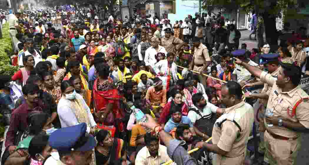 Police manage the crowd at Tirupati's temple after a stampede left six dead. 