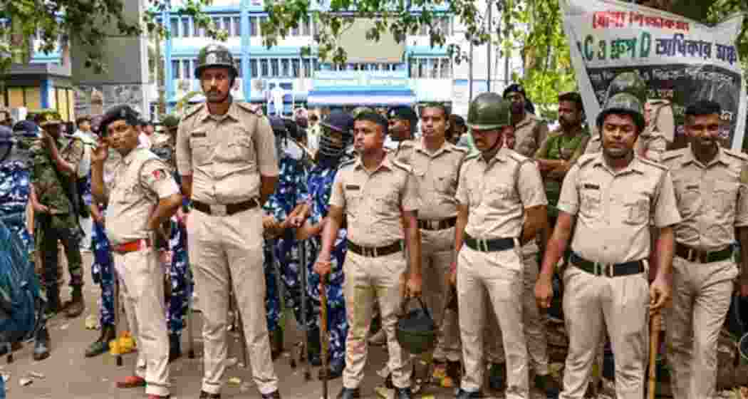 West Bengal police stand guard in Murshidabad after the murder of a TMC worker.