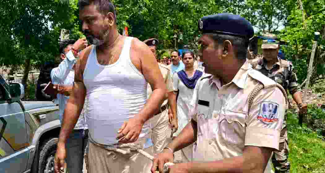 Police personnel escort TMC youth leader Abhijit Roy, also known as Boni, through a locality in Kanchrapara with a rope tied around his waist after his arrest, drawing public attention and sparking political controversy.