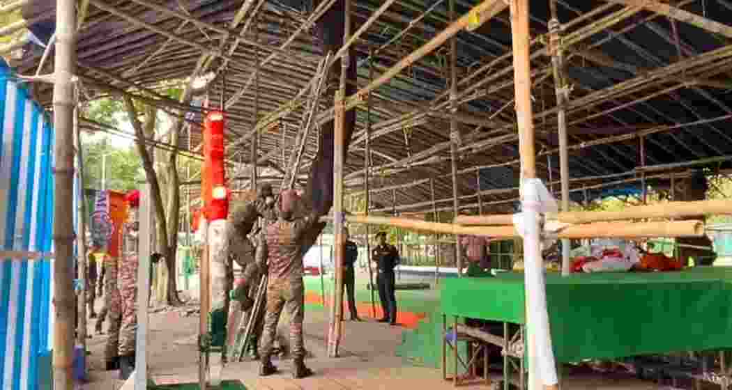 Indian Army personnel dismantle TMC's temporary stage for protests in Kolkata on Monday.