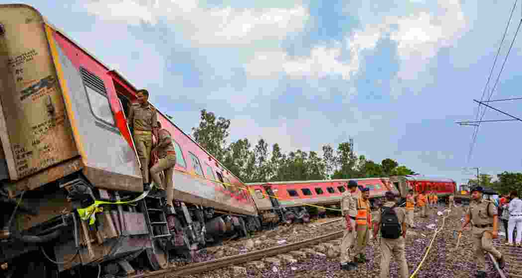 Police personnel inspect the derailed coaches of the Chandigarh-Dibrugarh Express, in Gonda district, Thursday, July 18, 2024. At least four passengers were killed and about 20 injured in the incident, according to officials.
