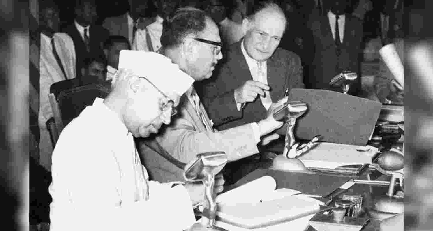 Prime Minister Jawaharlal Nehru, and Pakistani President Ayub Khan, centre, sign a treaty for the distribution of the Indus Basin waters in Karachi in September 1960.