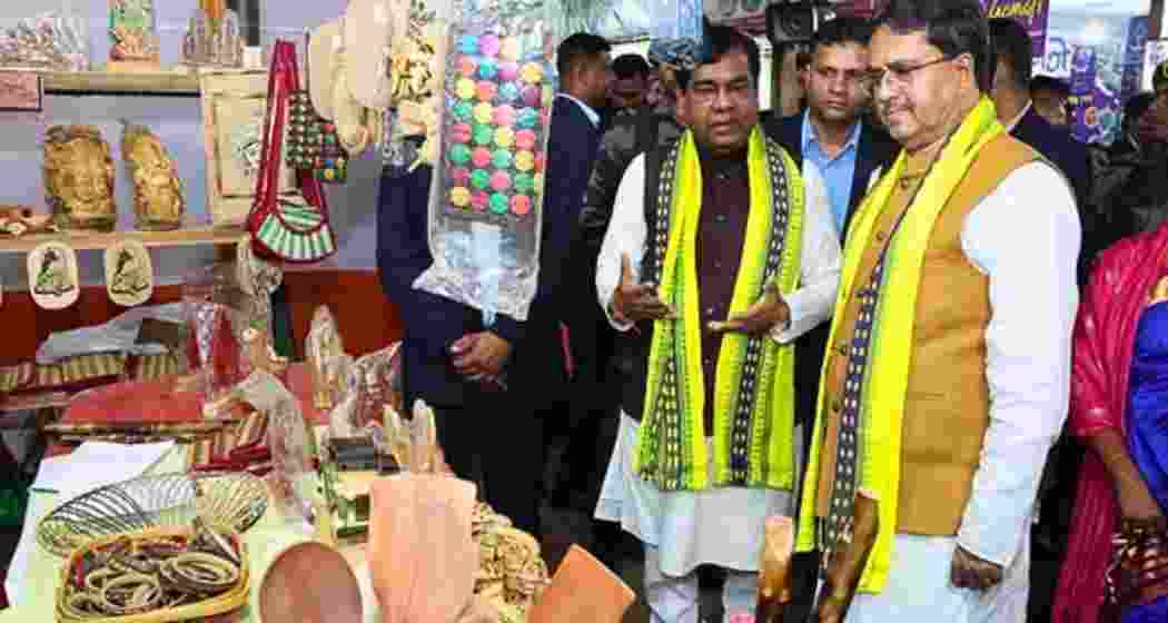 Tripura Chief Minister Manik Saha observes a Self-Help Group (SHG) stall run by women in Agartala during an event.