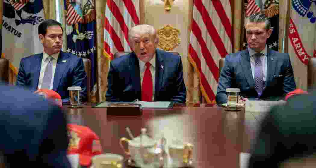 US President Donald Trump speaks during an event as Vice President JD Vance and Defence Secretary Pete Hegseth look on.