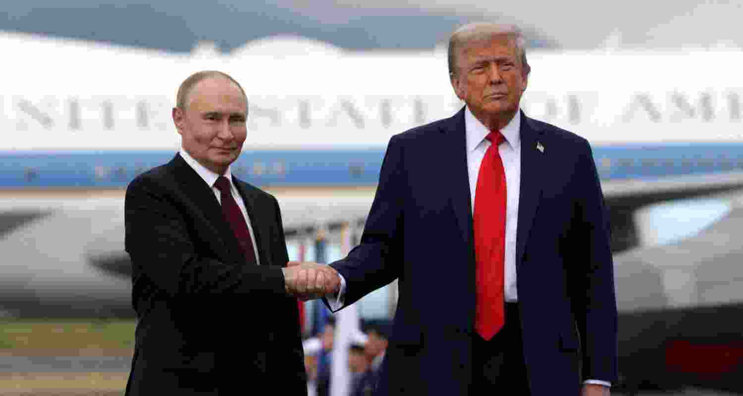 In this pool photograph distributed by the Russian state agency Sputnik, US President Donald Trump and Russian President Vladimir Putin shake hands after their arrival for a US-Russia summit on Ukraine at Joint Base Elmendorf-Richardson in Anchorage, Alaska, on August 15.