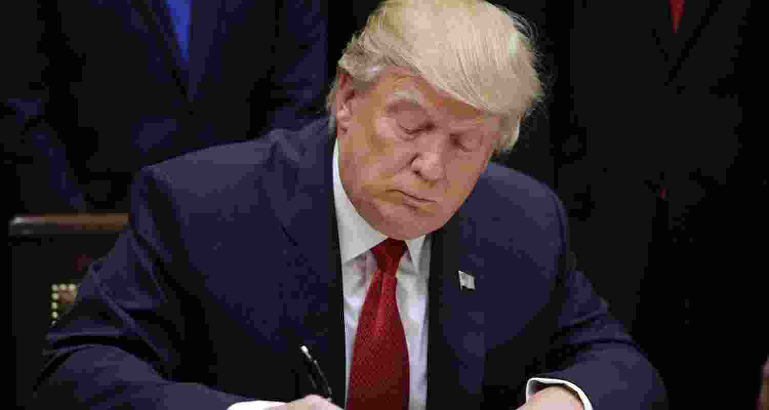 US President Trump signs an executive order. File Photo.
