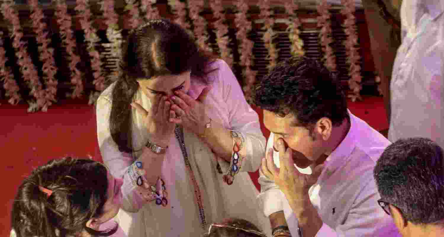 Cricket legend Sachin Tendulkar with wife Anjali pays tribute to singing legend Asha Bhosle during her public viewing, in Mumbai, Maharashtra, on Monday.