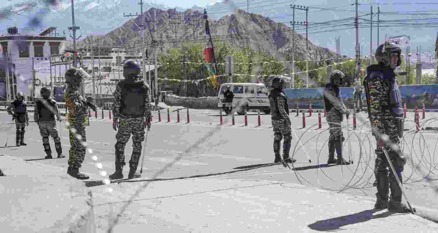 Security personnel stand guard on a road amid curfew, days after violence during protests for Ladakh Statehood, in Leh on Tuesday.