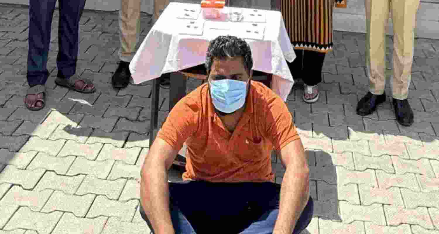 The cyber fraudster, who duped over 500 women, in police custody.