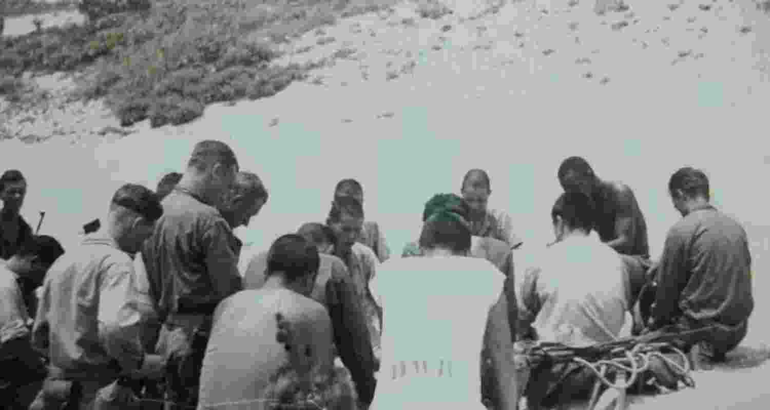 Japanese and American troops kneel in prayer on the island of Aka, June 1945. Image provided by researchers Nick Megoran and Hiroshi Sakai.