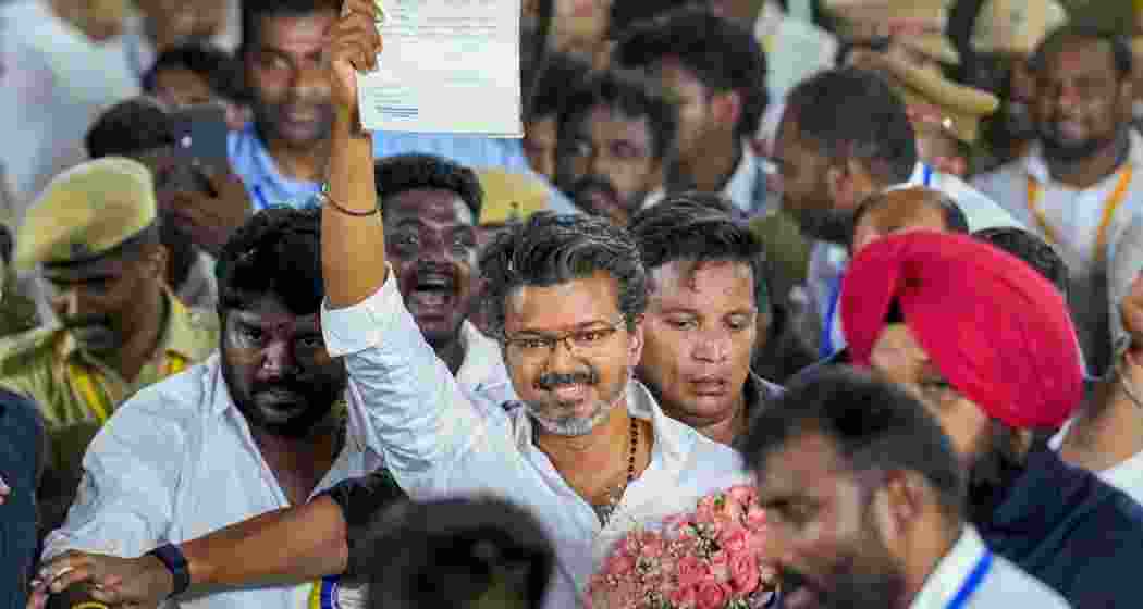 Tamilaga Vettri Kazhagam (TVK) chief and candidate from the Tiruchirappalli East constituency, Vijay, shows an election certificate outside a centre as he leads in vote counting for Tamil Nadu Assembly elections, in Chennai, Monday, May 4, 2026. 