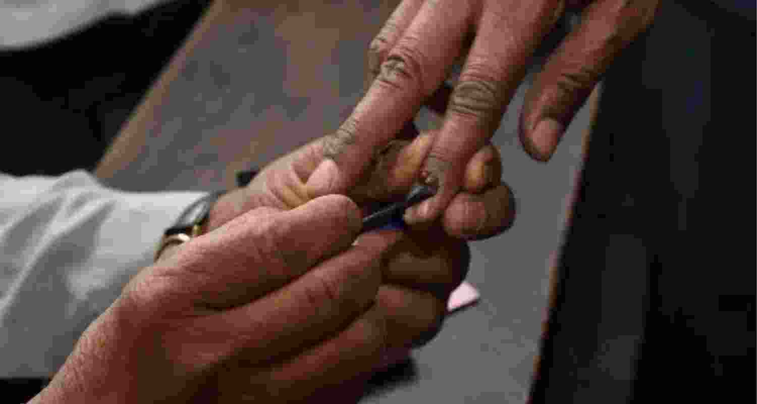 Voter getting inked after casting ballot.