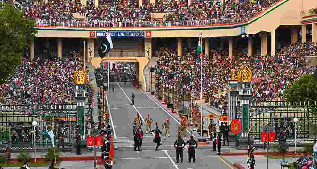 Indian BSF personnel and Pakistan Rangers take part in the Beating Retreat ceremony at the Wagah Border.