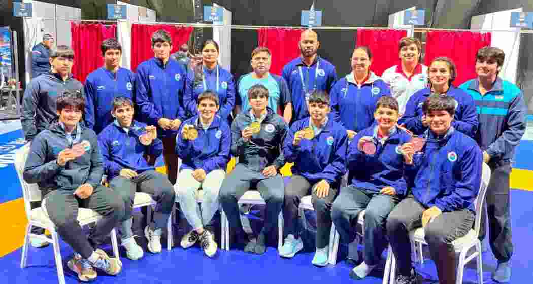 Athletes display their medals after competing at the Ulaanbaatar Open Senior Ranking Series wrestling tournament in Ulaanbaatar, Mongolia.
