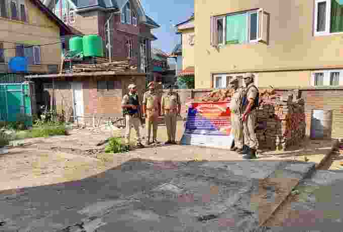 Officials of the police outside the property that has been attached