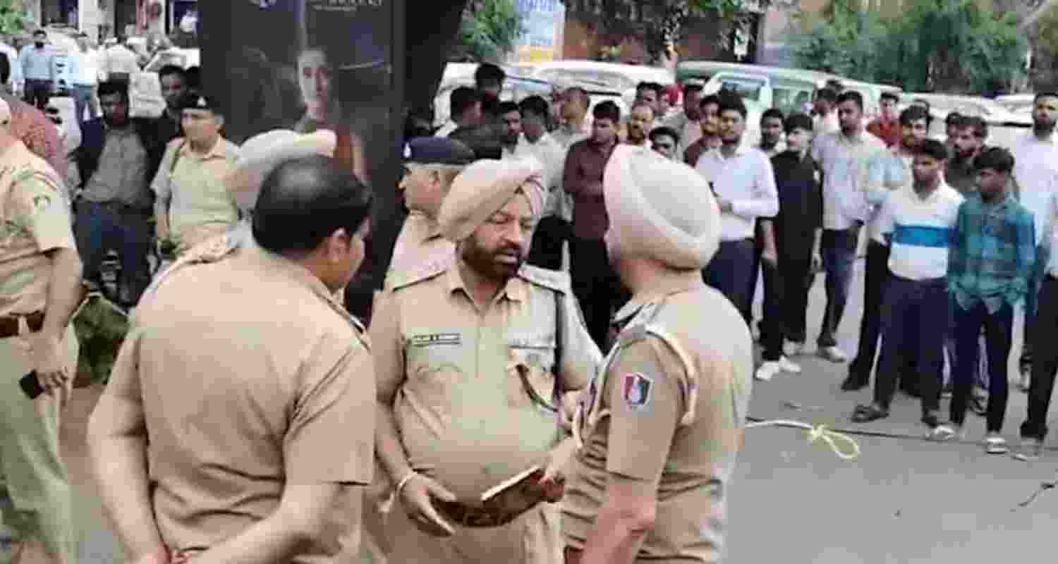 Police officers at the crime spot where a property dealer was shot dead, in Sector 9, Chandigarh, on Wednesday.