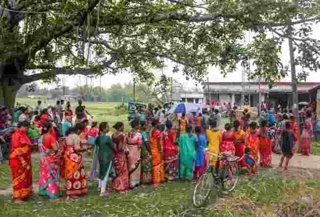 People wait in queues before voting in the first phase of the West Bengal Assembly elections, at a polling station in Dakshin Dinajpur, on Thursday.