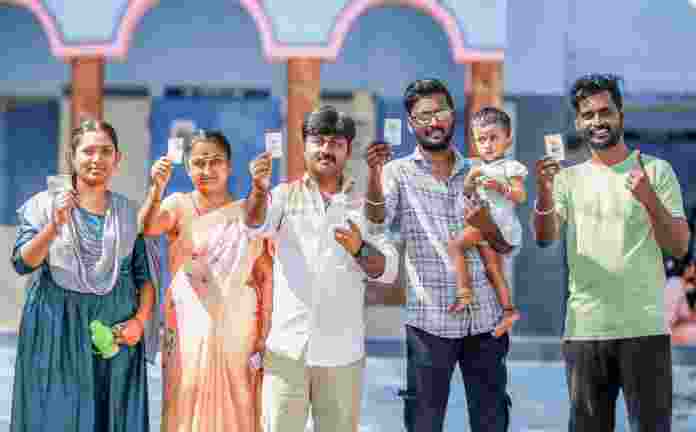 People show their ID cards during voting in the Tamil Nadu Assembly elections, in Virudhunagar, on Thursday.