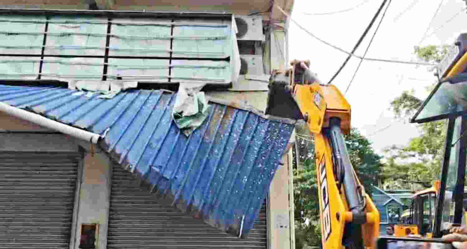 A JCB machine pressed into action to demolish TMC MP Abhishek Banerjee's office in Amtala, South 24 Parganas, on Saturday.