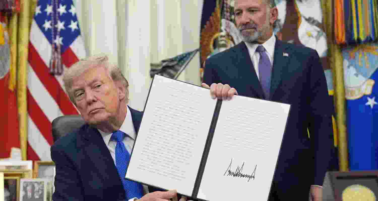 President Donald Trump holds a signed proclamation regarding polysilicon imports in the Oval Office of the White House on Thursday.